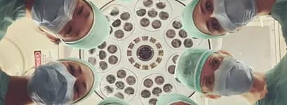 Surgical team seen from below an operating light