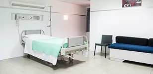 Empty patient room with a bed
